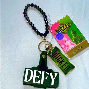 WICKED DEFY GRAVITY Green and Black Keyring Bracelet. CLAIRES BRAND NEW